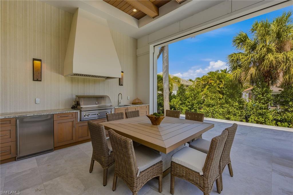 529 Neapolitan Way Naples, FL 34103 - Photo 11 of 26 a kitchen with a table and chairs in it