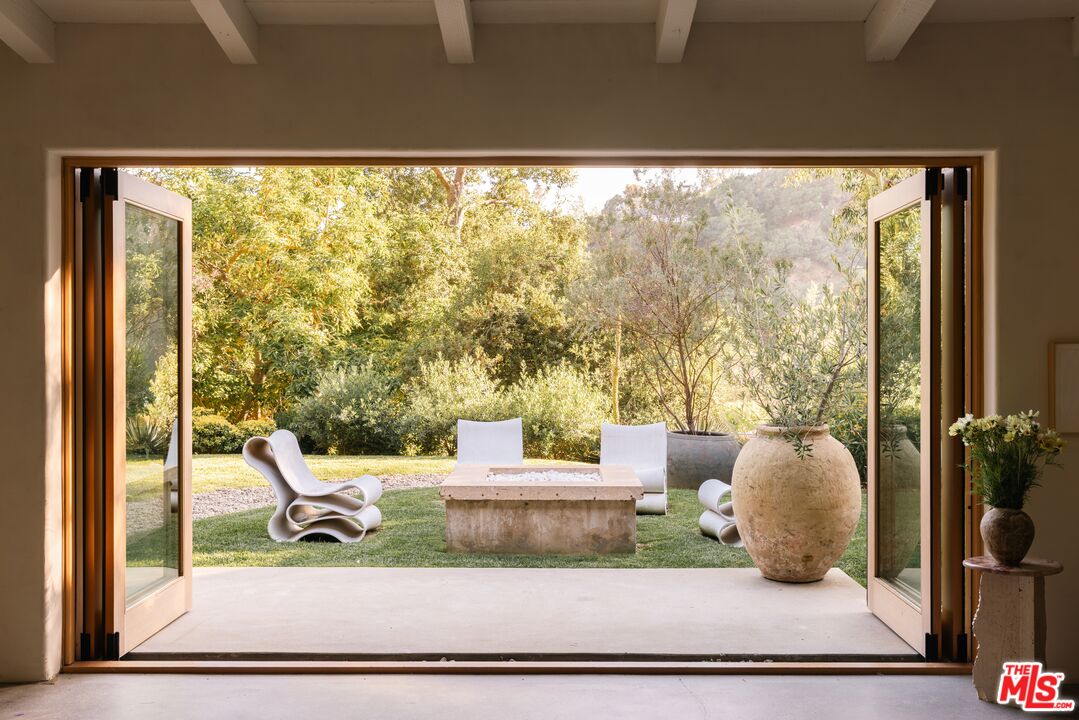 1830 Old Orchard Road Los Angeles, CA 90049 - Photo 9 of 30 view of living room with furniture and garden view