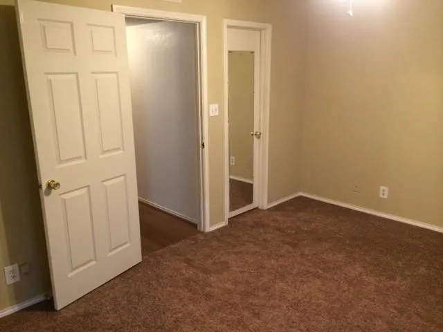 an empty room with closet area