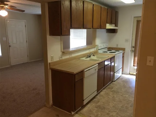 a kitchen that has a sink and a stove