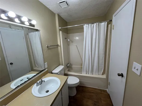 a kitchen with a stove a sink and a microwave