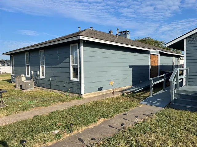 a backyard of a house with barbeque oven and outdoor seating