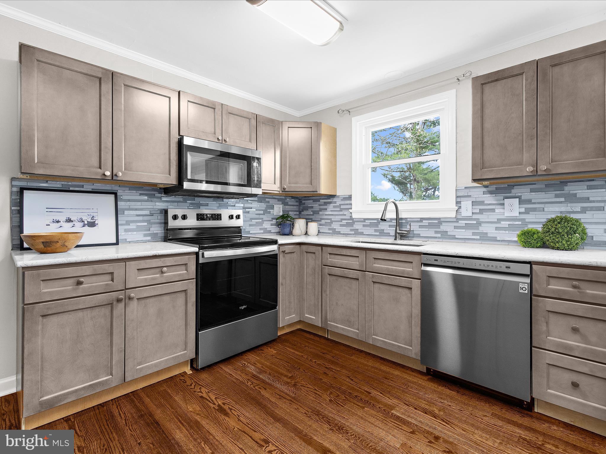208 Ewingtown Road Church Hill, MD 21623 - Photo 10 of 62 a kitchen with granite countertop wooden floors appliances cabinets and a window
