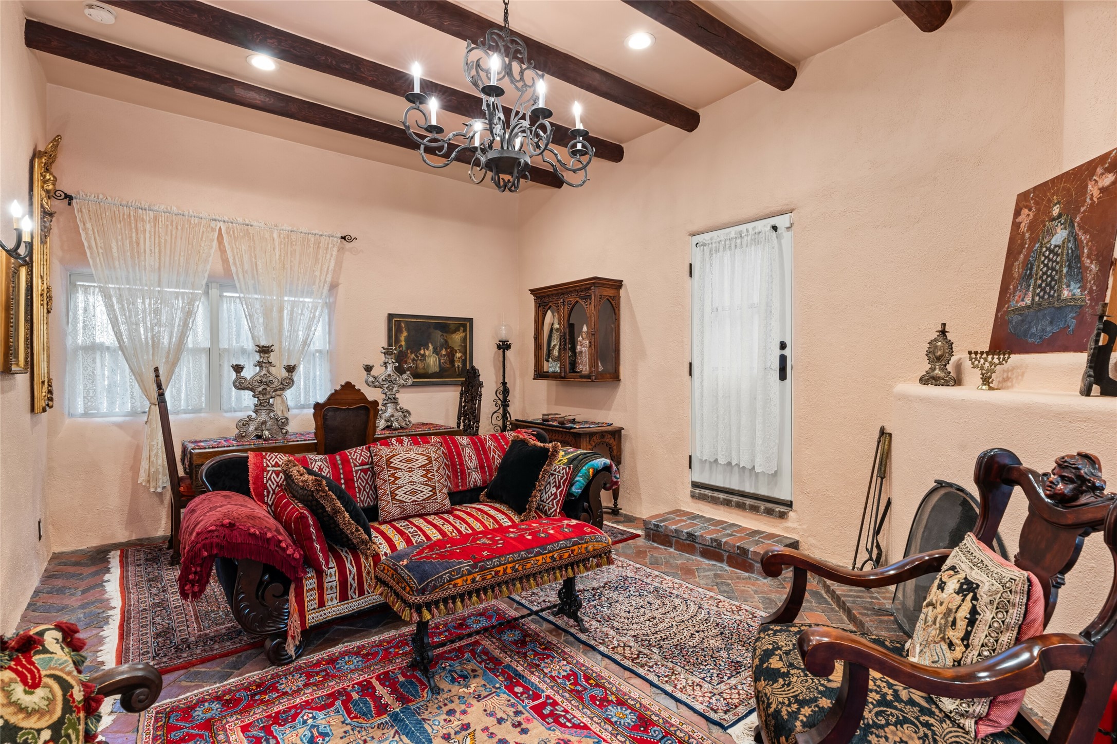 224 Artist Road, Unit 1 Santa Fe, NM 87501 - Photo 3 of 22 Living Room w/ Corner Kiva Fireplace & Access to Back Patio
