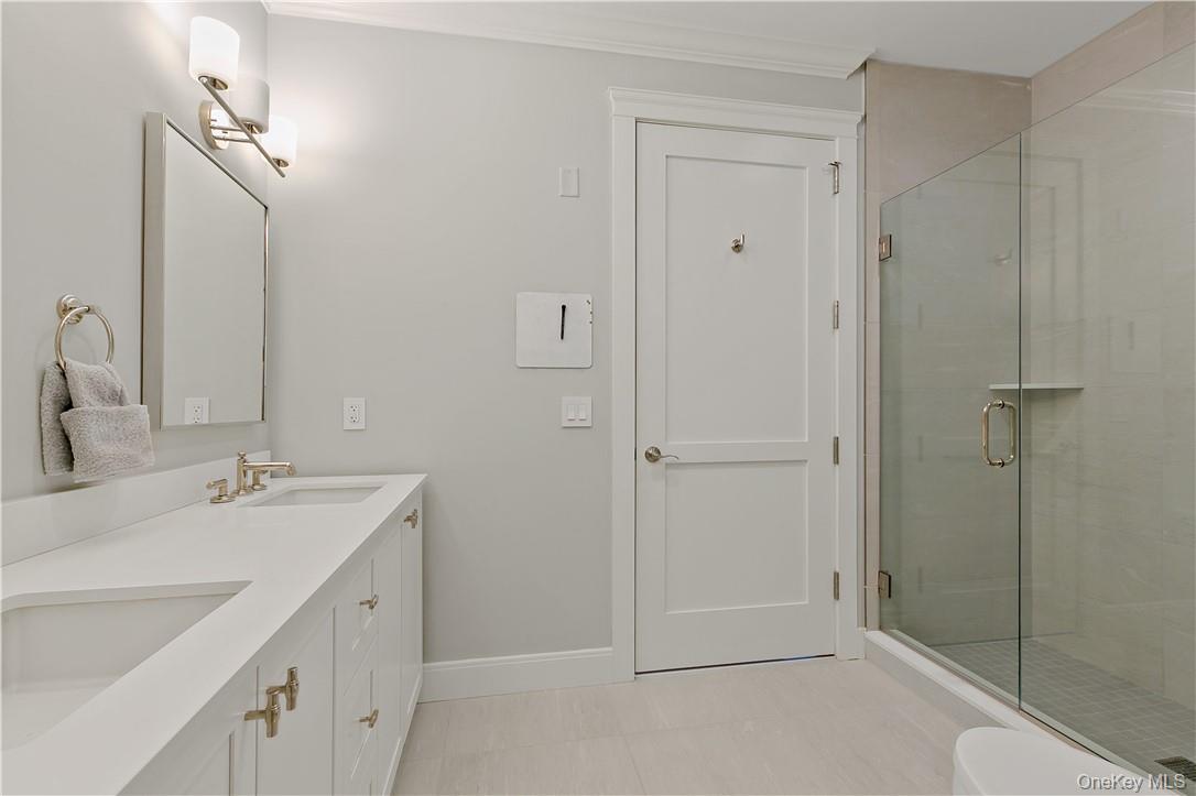 45 Hudson View Way Tarrytown, NY 10591 - Photo 15 of 26 a bathroom with a double vanity sink mirror and shower