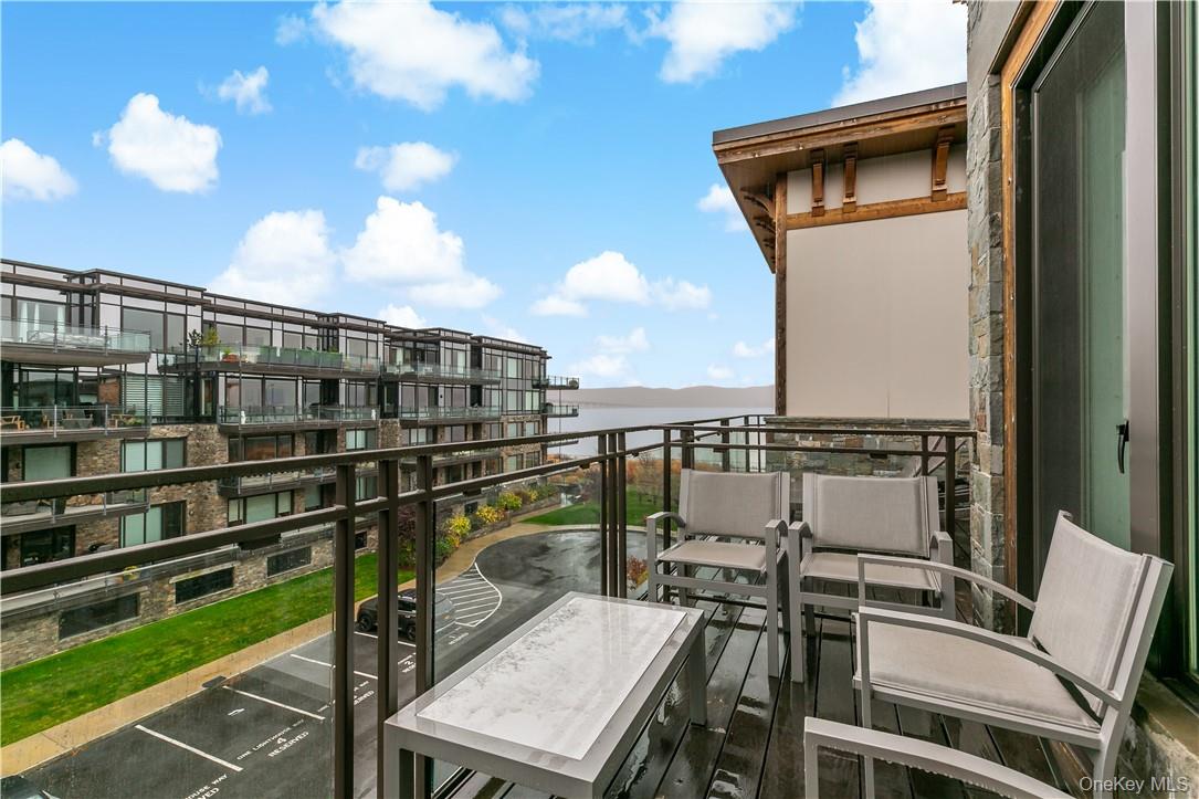 45 Hudson View Way Tarrytown, NY 10591 - Photo 17 of 26 a view of a balcony with two chairs and a potted plant on a table