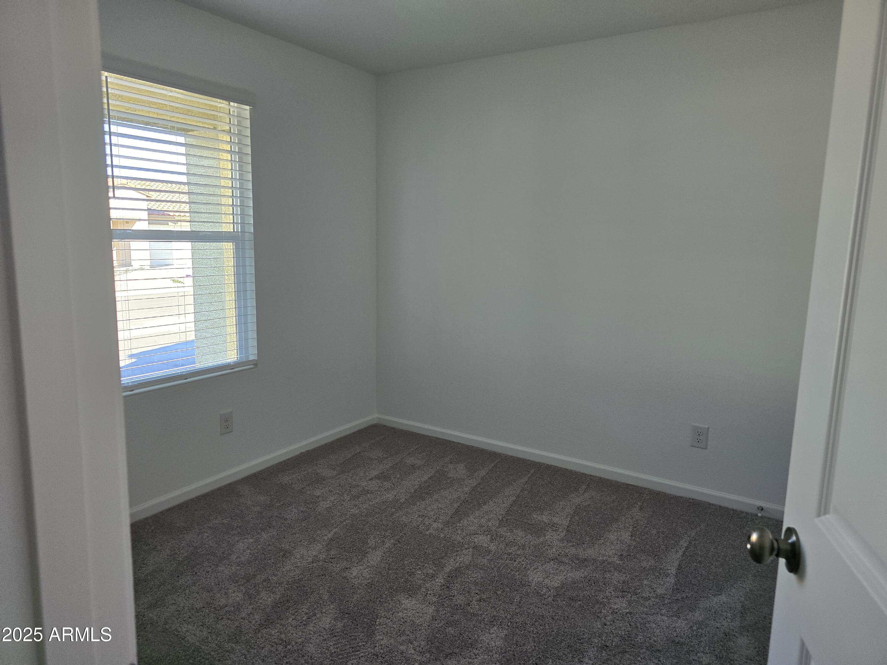 729 Dylan Court Wickenburg, AZ 85390 - Photo 2 of 14 an empty room with a window