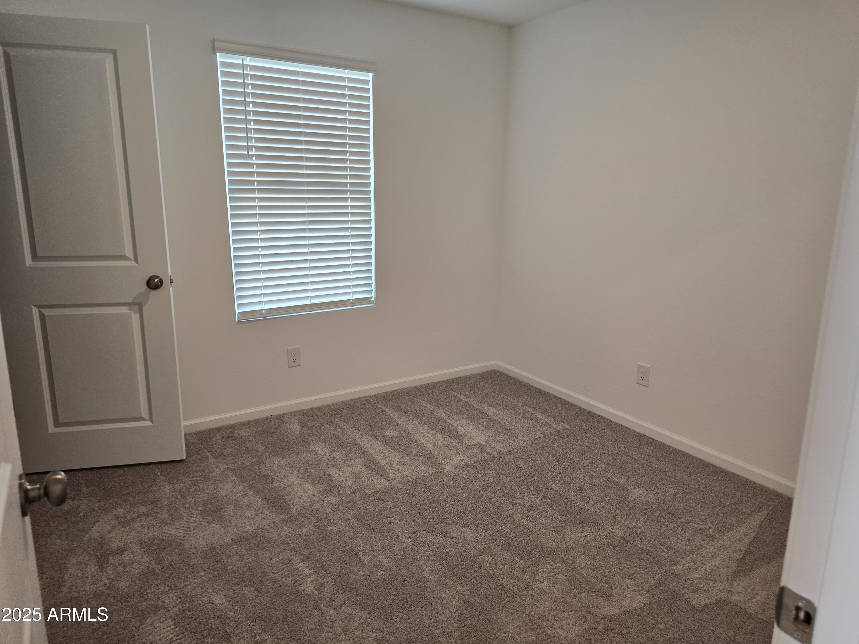 729 Dylan Court Wickenburg, AZ 85390 - Photo 4 of 14 an empty room with a window