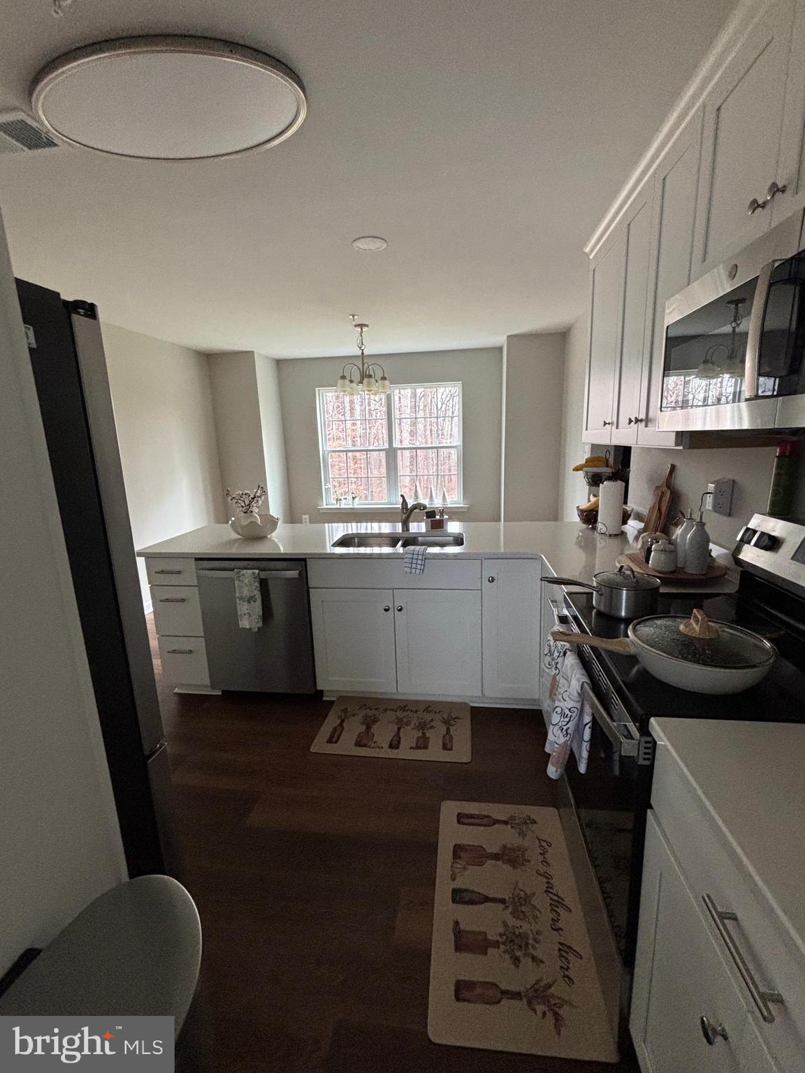 101 Anchor Lane Lusby, MD 20657 - Photo 12 of 45 a kitchen with a sink a stove a refrigerator and a window