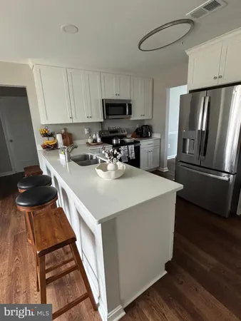 a kitchen with a sink a stove and a refrigerator