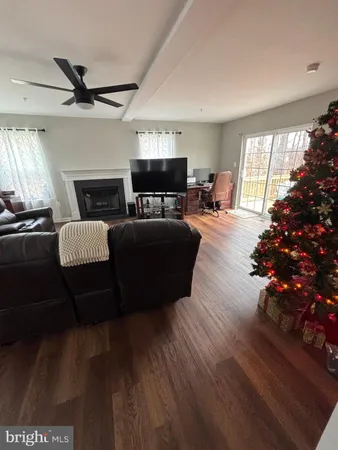 a living room with furniture fireplace and flat screen tv
