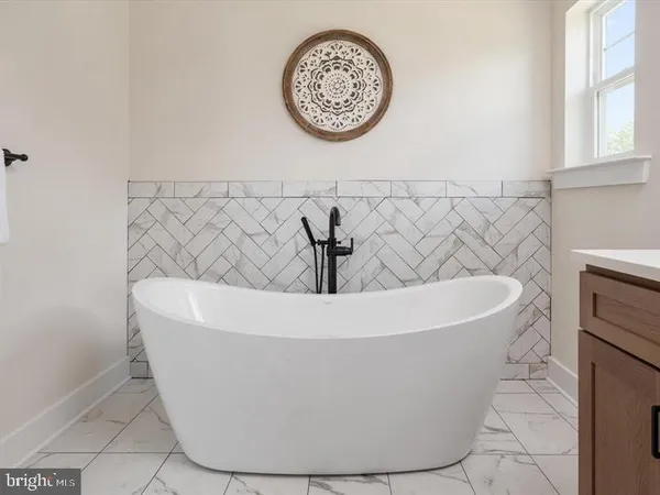 a white bath tub sitting in a bathroom