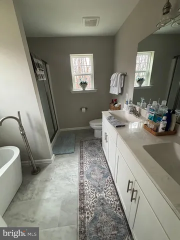 a spacious bedroom with a bed and window