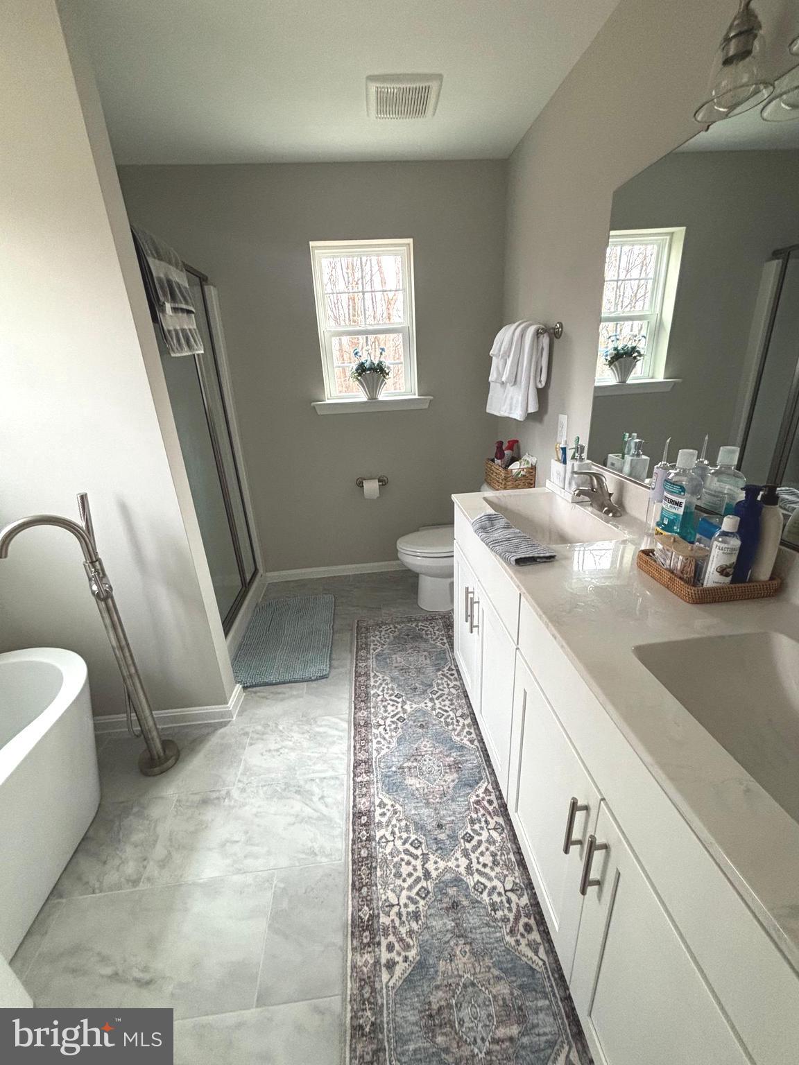 101 Anchor Lane Lusby, MD 20657 - Photo 29 of 45 a spacious bathroom with a double vanity sink a toilet and a mirror