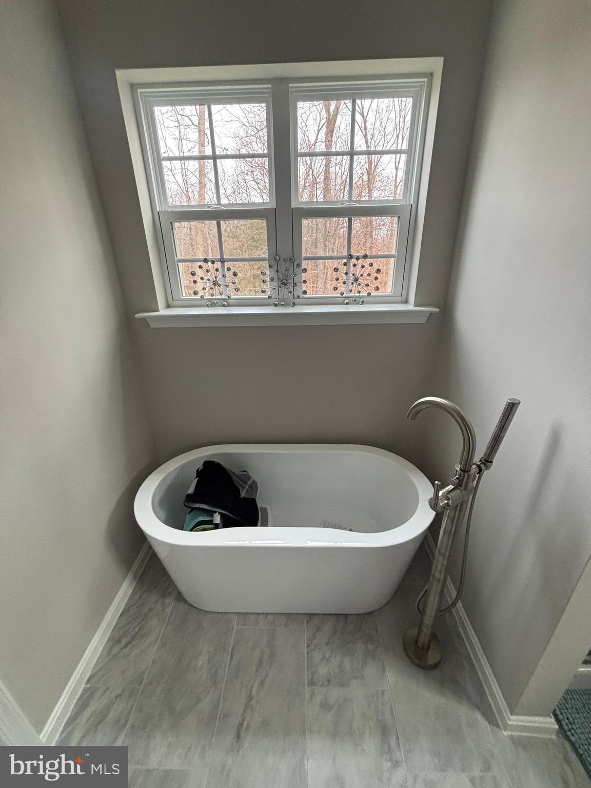 101 Anchor Lane Lusby, MD 20657 - Photo 30 of 45 a white bath tub sitting in a bathroom next to a window