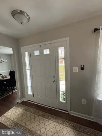 a view of a livingroom with entryway and window