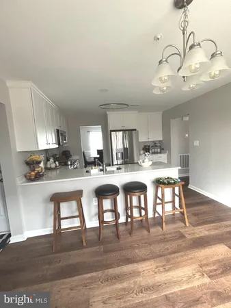 a kitchen with lots of wooden furniture and appliances
