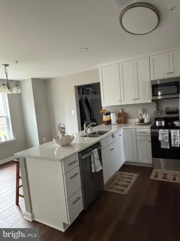 a kitchen with a sink a stove a refrigerator and a window