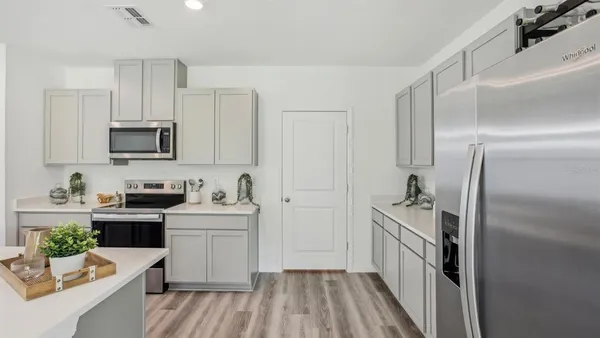 a kitchen with a sink stove and refrigerator