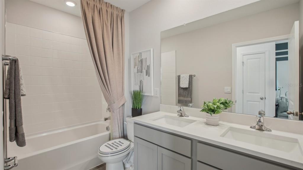 35529 Brick Church Loop Dade City, FL 33525 - Photo 24 of 36 a bathroom with a granite countertop sink toilet and shower
