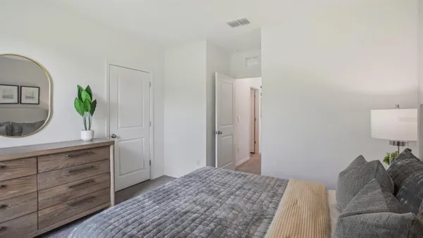 a bedroom with a bed and a dresser in it