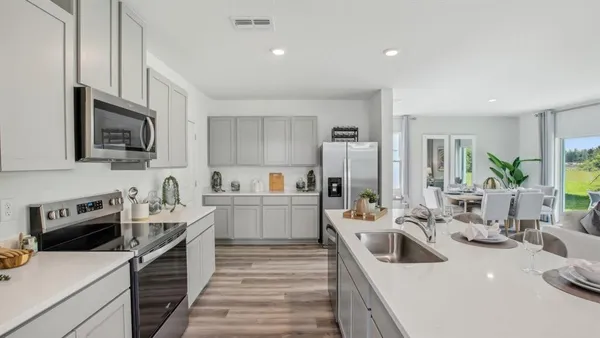 a kitchen with a sink stove and refrigerator