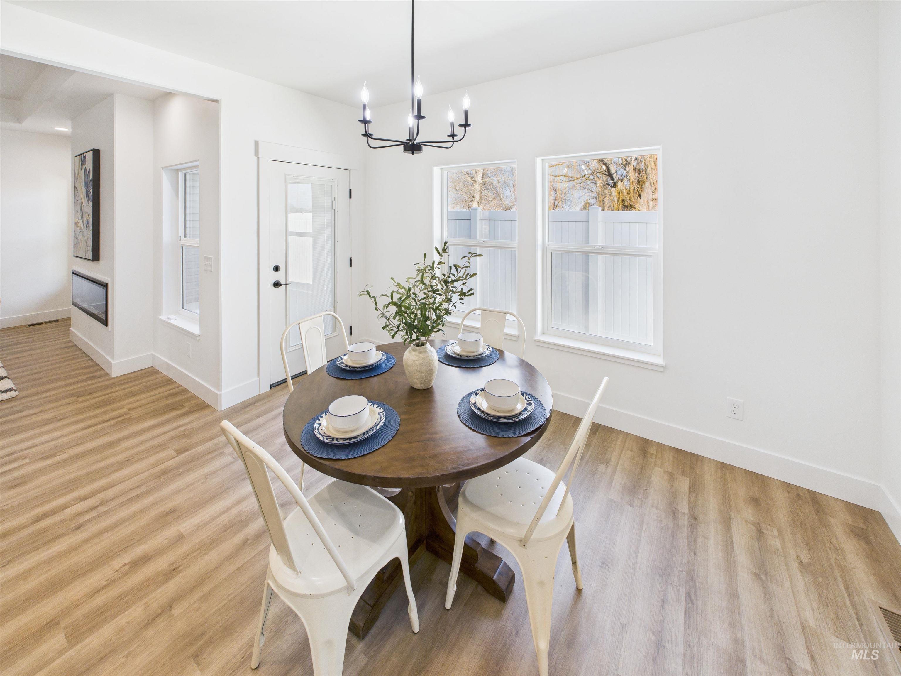 1216 Bronze Drive Rupert, ID 83350 - Photo 11 of 28 Dining area featuring a chandelier and light wood-type flooring