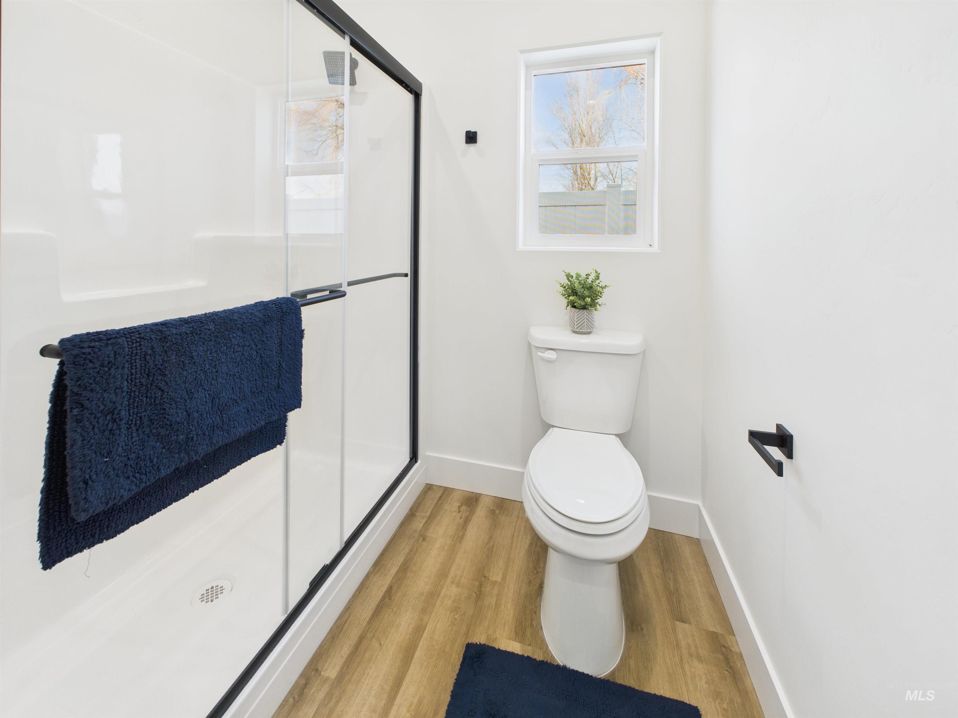 1216 Bronze Drive Rupert, ID 83350 - Photo 17 of 28 Full bath with a stall shower and wood finished floors