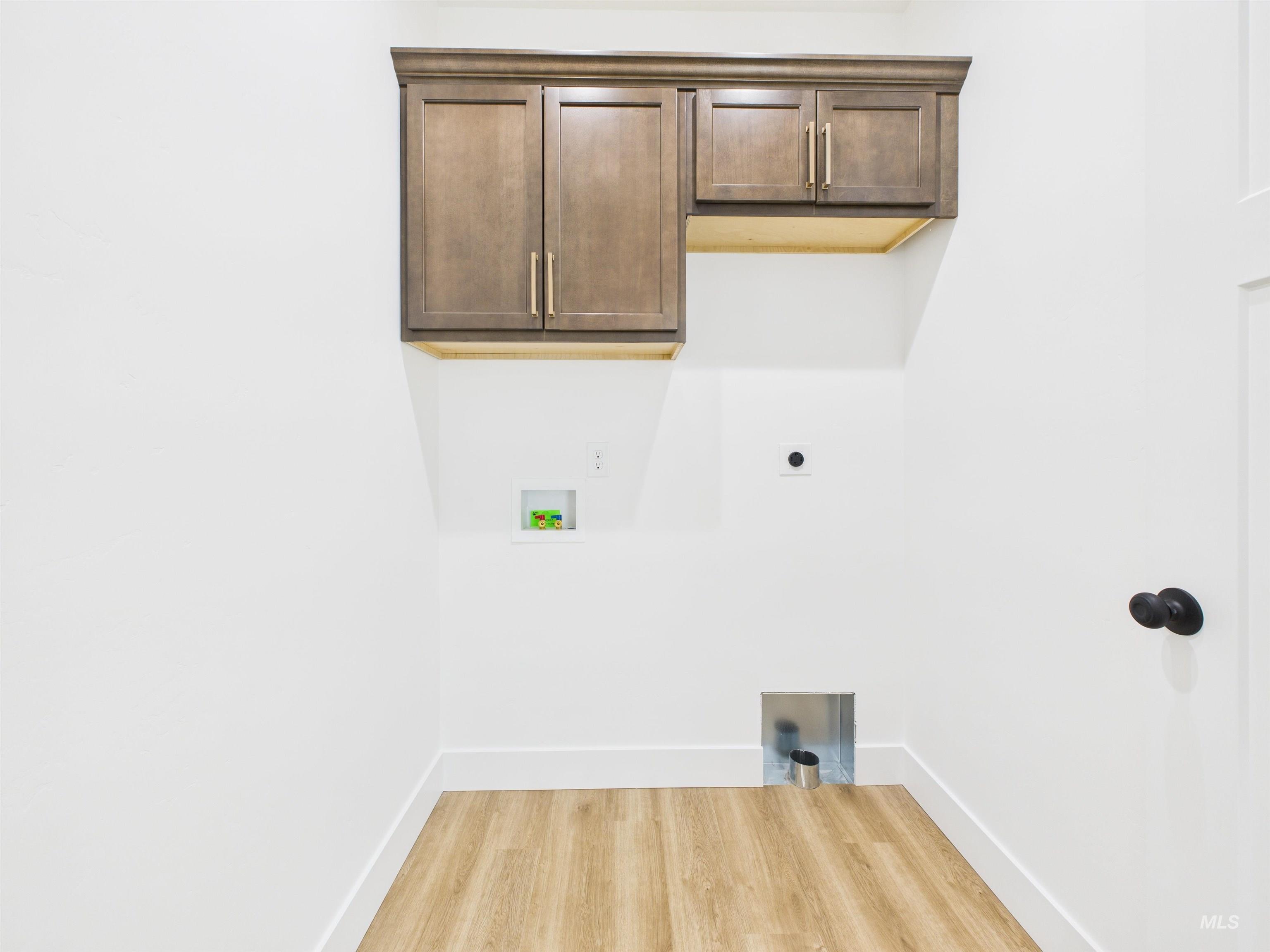 1216 Bronze Drive Rupert, ID 83350 - Photo 20 of 28 Washroom featuring cabinet space, light wood finished floors, hookup for an electric dryer, and washer hookup
