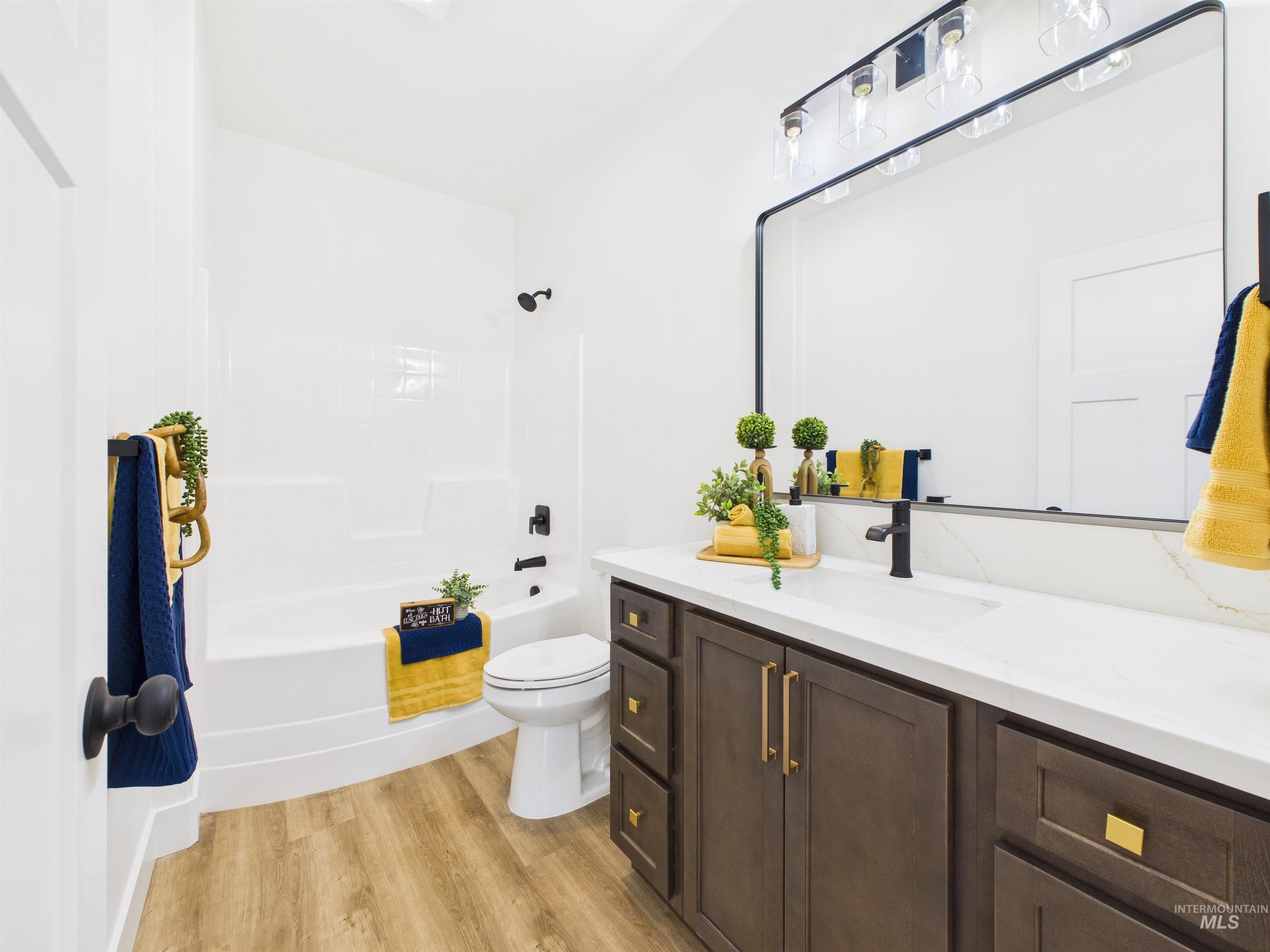 1216 Bronze Drive Rupert, ID 83350 - Photo 21 of 28 Bathroom featuring vanity, bathtub / shower combination, and light wood finished floors