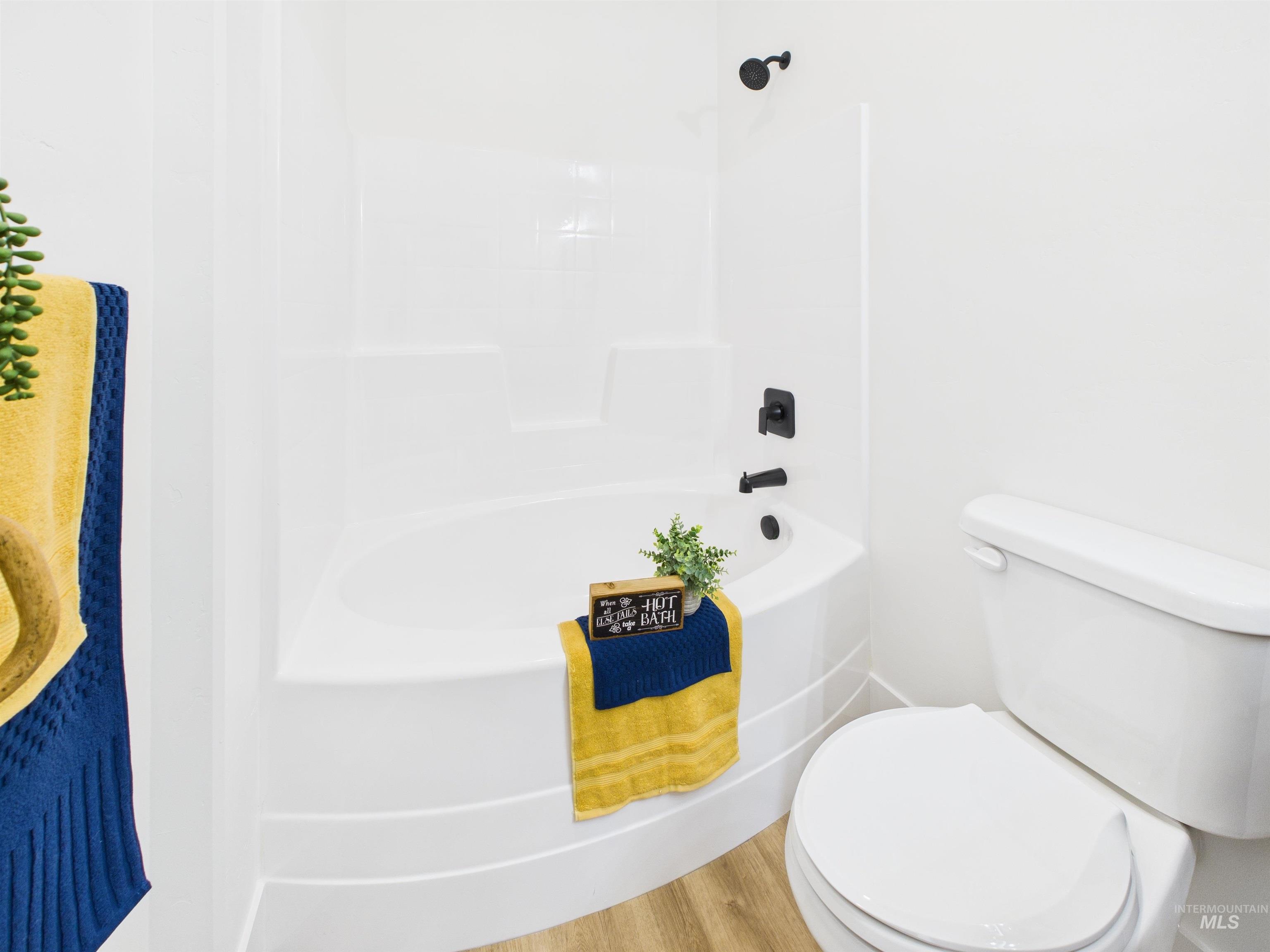 1216 Bronze Drive Rupert, ID 83350 - Photo 22 of 28 Bathroom featuring wood finished floors and washtub / shower combination