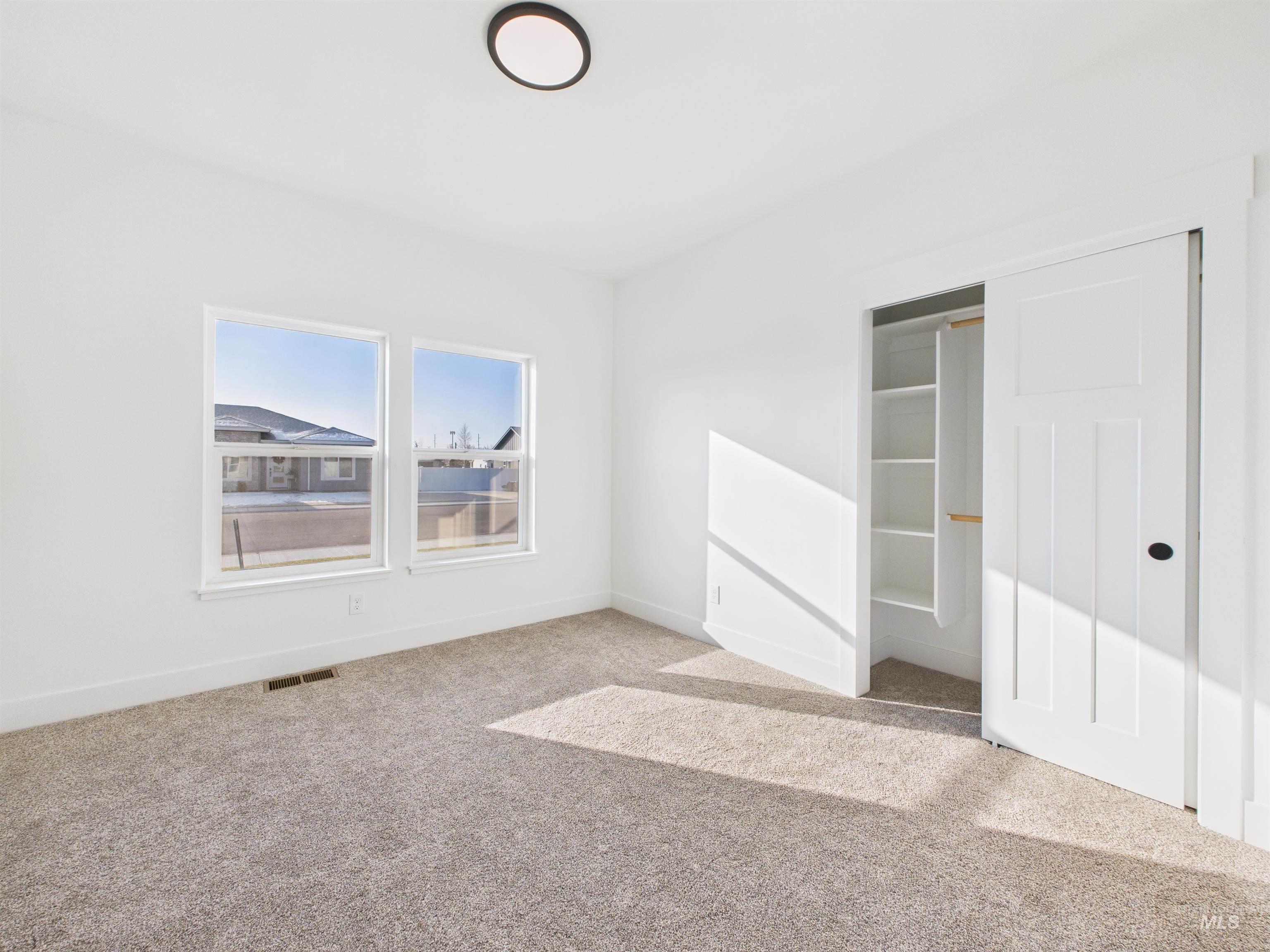 1216 Bronze Drive Rupert, ID 83350 - Photo 26 of 28 Unfurnished bedroom with light colored carpet and a closet