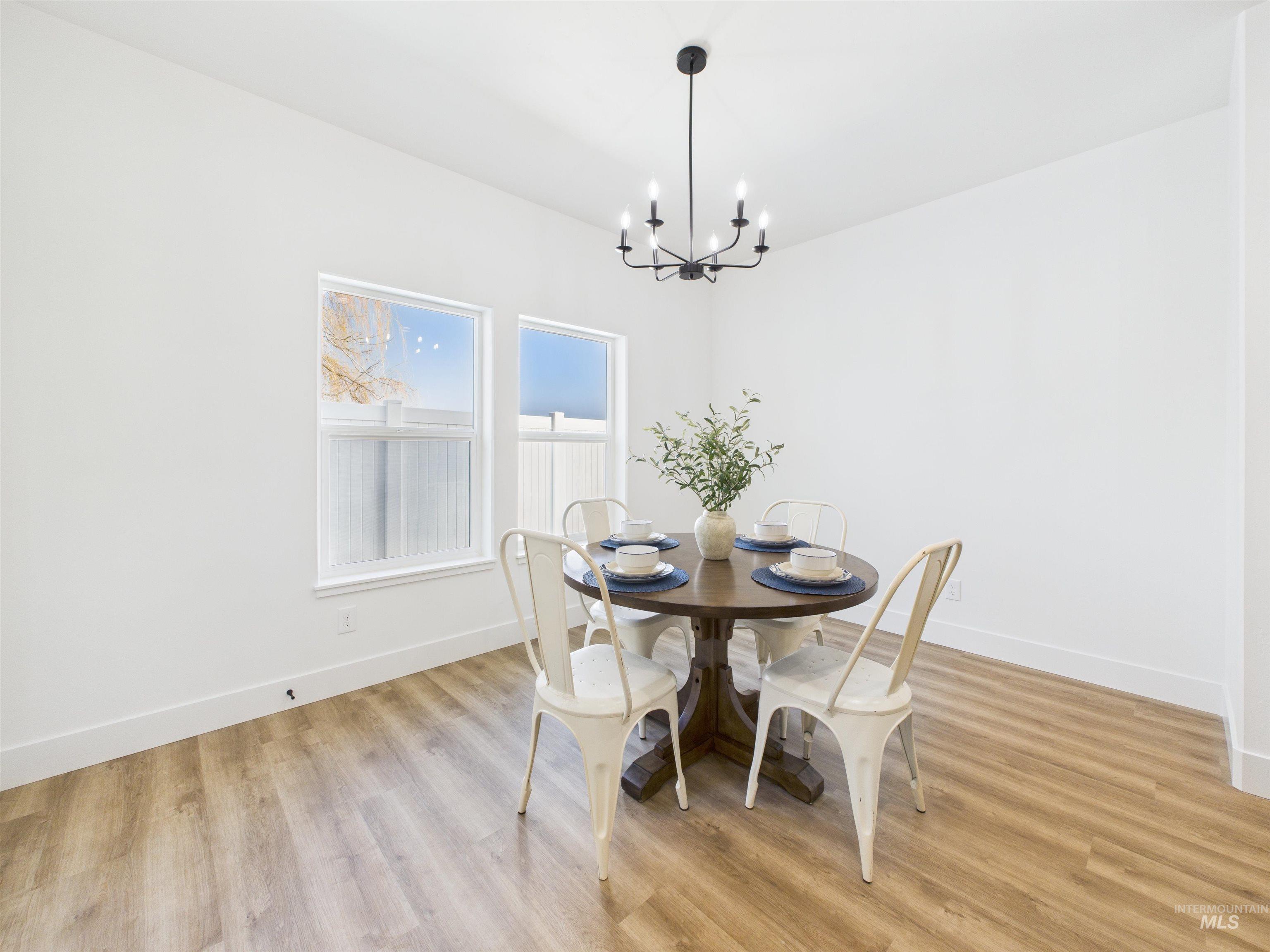 1216 Bronze Drive Rupert, ID 83350 - Photo 9 of 28 Dining space with light wood-type flooring and a chandelier