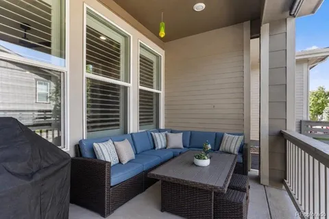 a view of a patio with couches and a dining table with balcony view