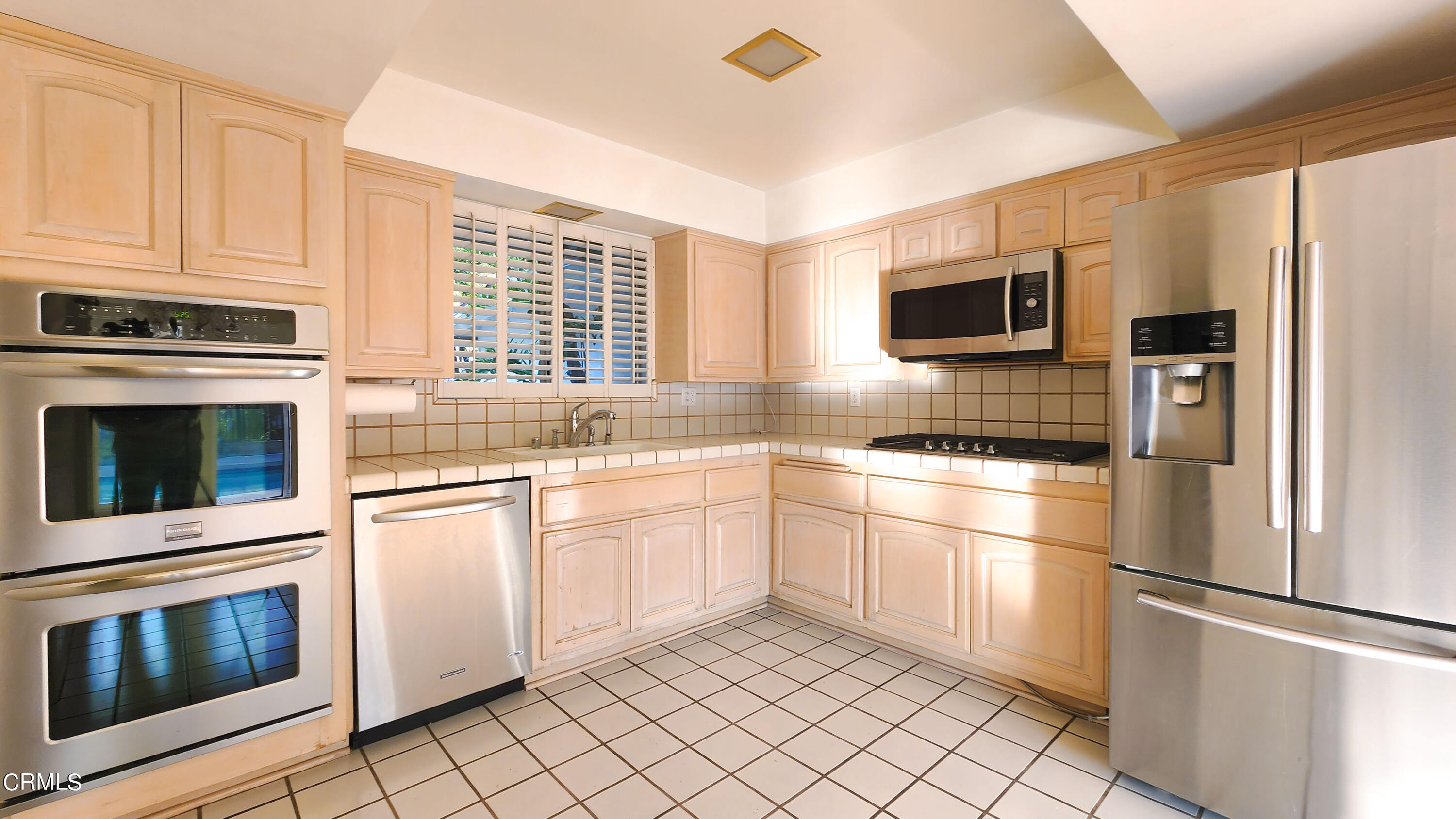 1980 Crestshire Drive Glendale, CA 91208 - Photo 12 of 27 a kitchen with granite countertop cabinets stainless steel appliances and a window
