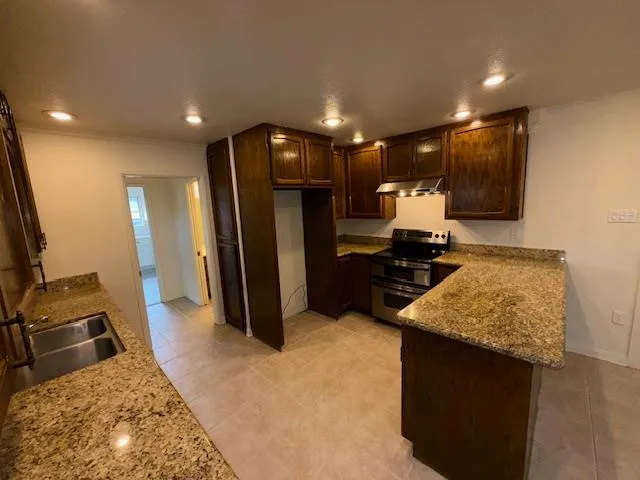 a view of kitchen with microwave and refrigerator
