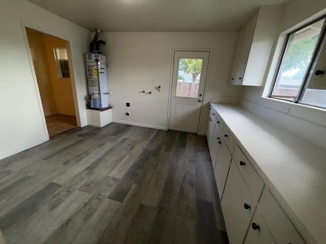 a view of a house with backyard and chairs