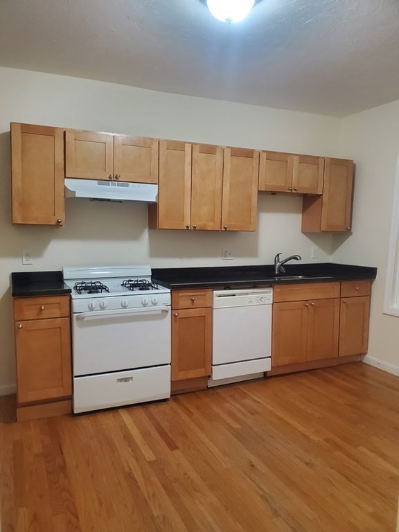 a kitchen with a stove and a cabinets
