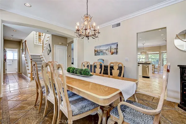 a view of a dining room with furniture and chandelier