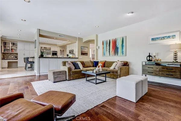 a living room with furniture and kitchen view