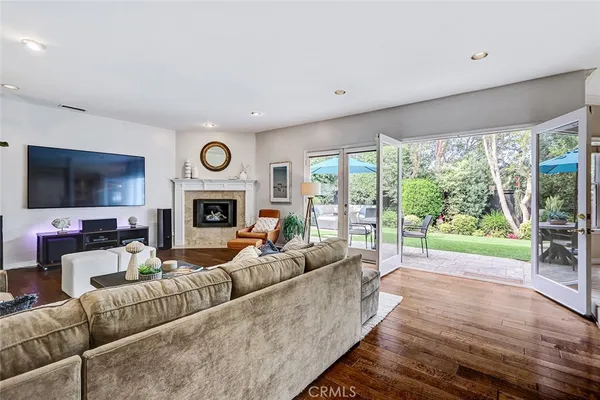a living room with furniture a large window and a fireplace