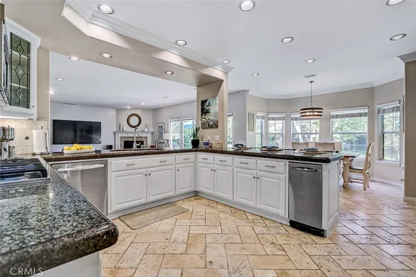 a kitchen with stainless steel appliances granite countertop a sink and cabinets