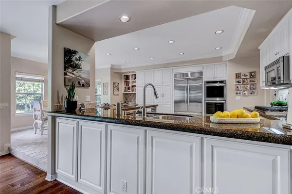 a kitchen with lot of counter space and wooden floor