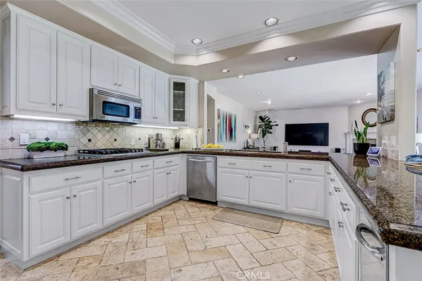 a kitchen with stainless steel appliances granite countertop a sink and cabinets