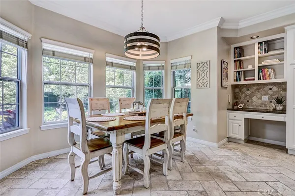 a dining room with furniture window chandeliers