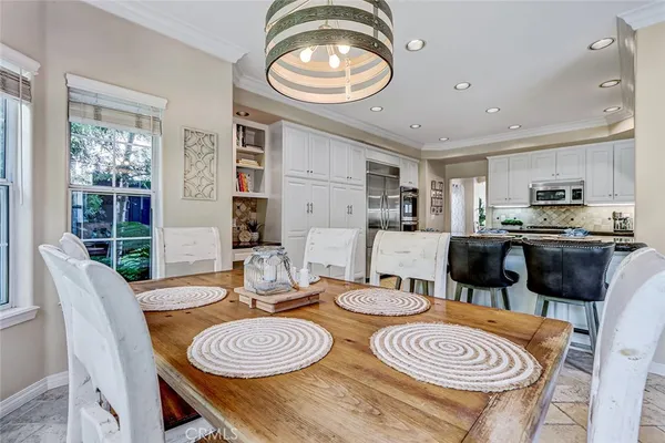 a dining room with furniture and a window