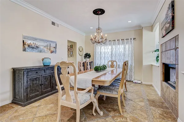 a dining room with furniture a chandelier and window