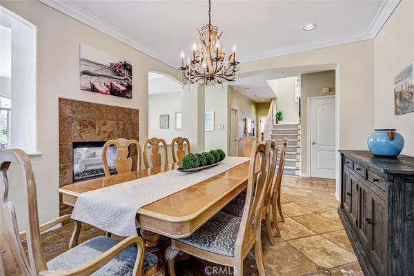 a view of a dining room with furniture and a chandelier