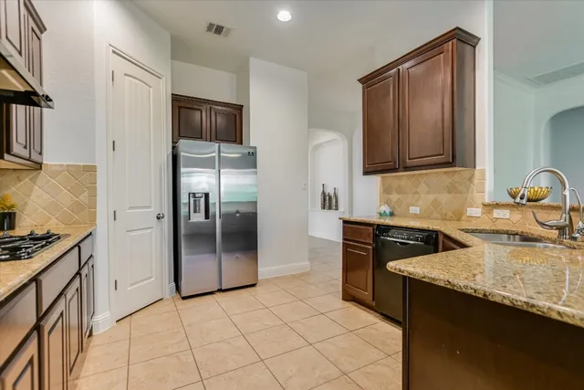 a view of an empty room with a fireplace and a window