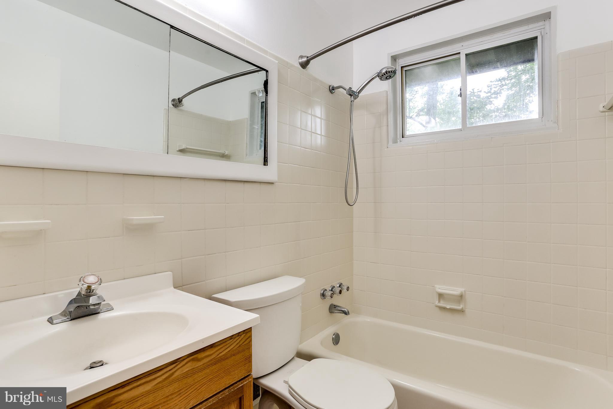 12714 Helen Road Silver Spring, MD 20906 - Photo 12 of 19 a bathroom with a sink toilet and shower